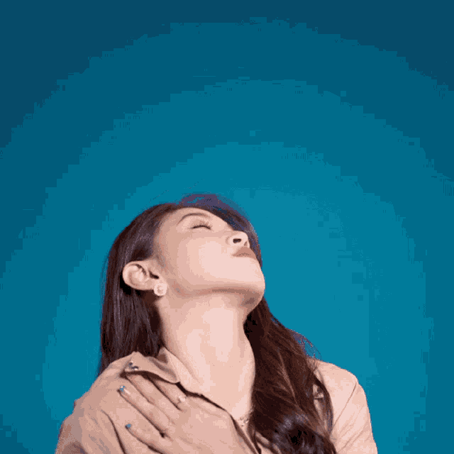 a woman with her eyes closed is wearing earrings