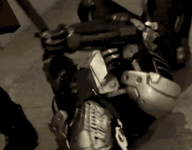 a close up of a person wearing a helmet and knee pads with the letter t on them