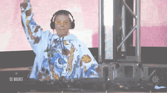 a dj wearing headphones and a sweatshirt with flames on it
