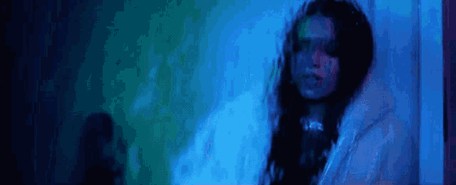 a blurry picture of a woman in a blue room