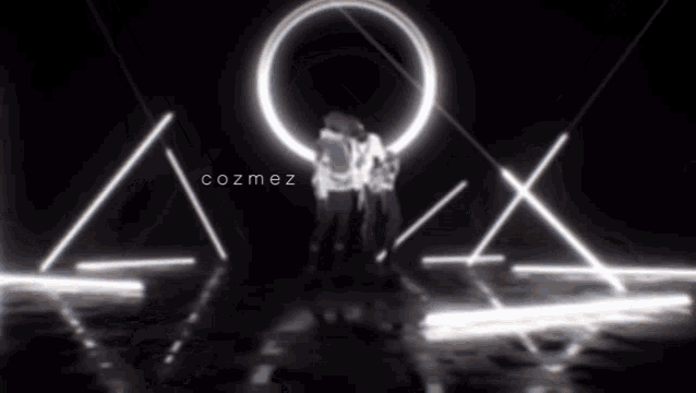two people standing in front of a circle with cozmez written on it