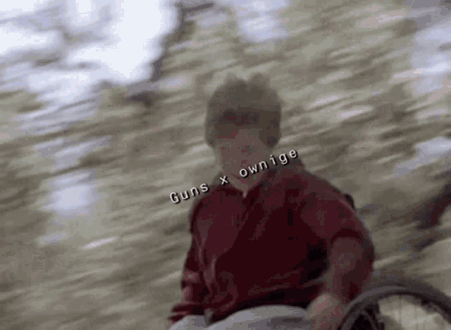 a man in a wheelchair with the words guns x ownige written on the bottom
