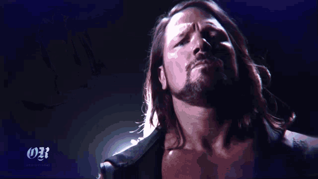 a man with long hair and a beard is standing in front of a blue background with the letters 031 on it