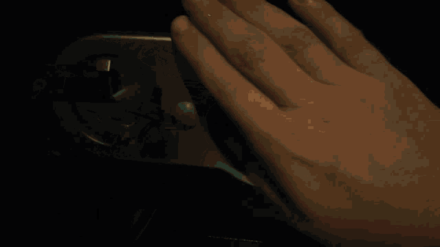 a close up of a person 's hand on a door handle