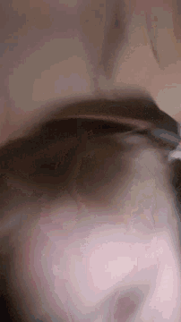 a close up of a person 's face with a blurred image