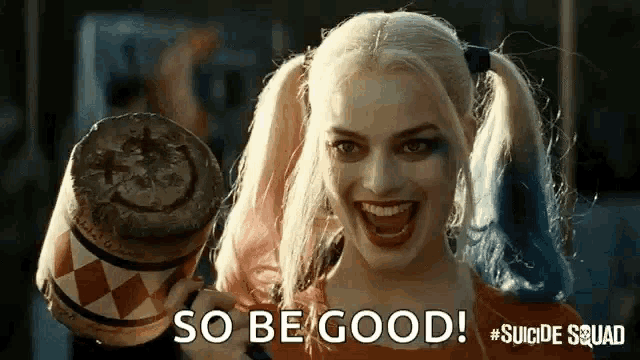 harley quinn from the suicide squad is smiling and holding a mallet in her hand .