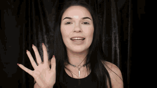 a woman holding a plaque that says youtube.com/aliceclockhart
