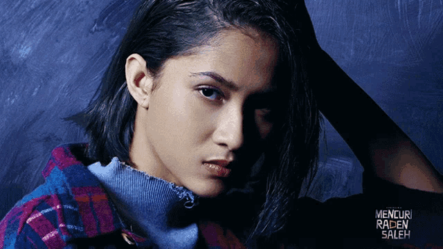 a close up of a woman 's face with the words mencuri raden saleh in the corner