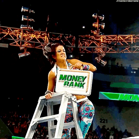a woman is standing on a ladder with a sign that says money bank