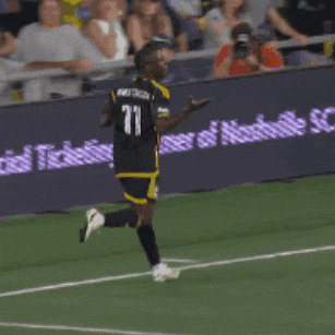 a soccer player with the number 11 on his back is running on the field