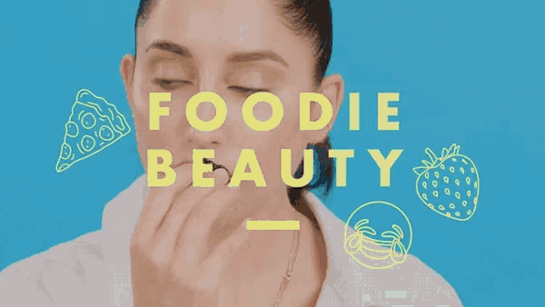 a woman is eating a slice of pizza with the words foodie beauty above her