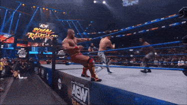 a wrestling match is taking place on a aew sponsored ring