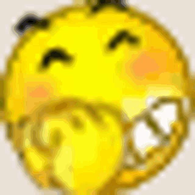 a close up of a yellow smiley face with big teeth and a blurry background .