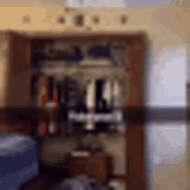 a blurry picture of a room with a closet and a couch .