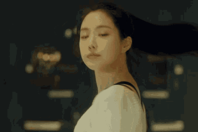 a woman 's hair is blowing in the wind