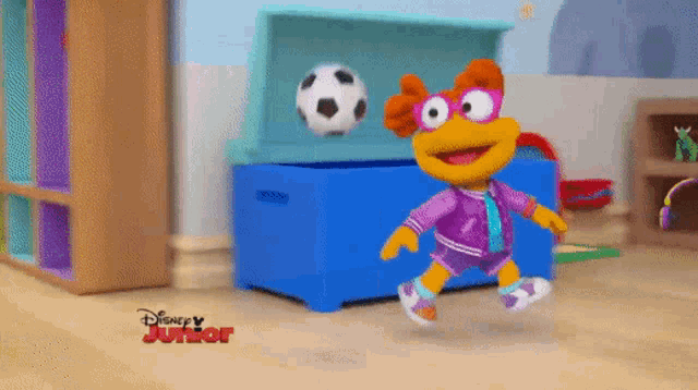 a cartoon character is playing with a soccer ball in a disney junior advertisement
