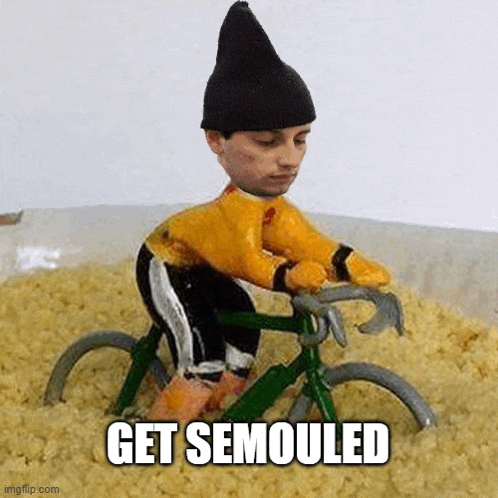 a figurine of a man riding a bike in a pile of rice .