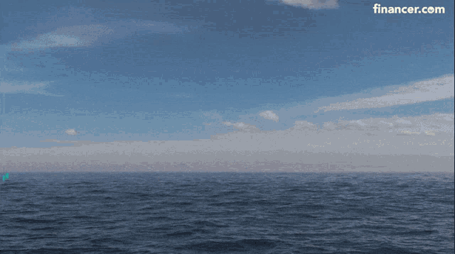 a blue circle with a bird on it is in the middle of the ocean with a financer.com logo in the corner