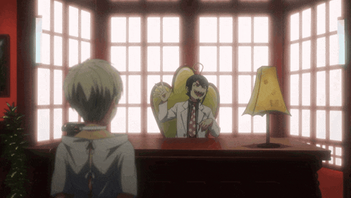 a man in a lab coat sits at a desk with a lamp