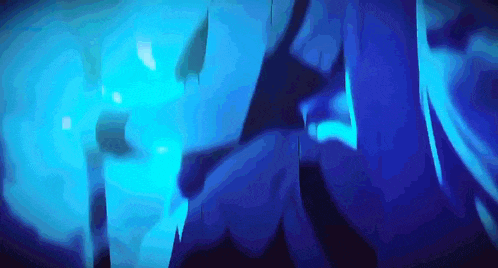 a person is standing in a dark room with blue lights behind them