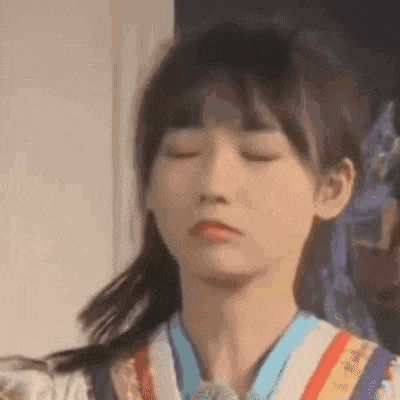 a close up of a young girl with her eyes closed .