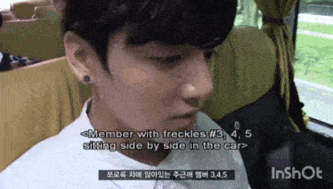 a man sitting in a car with the words member with freckles # 3 , 4 , 5 sitting side by side in the car