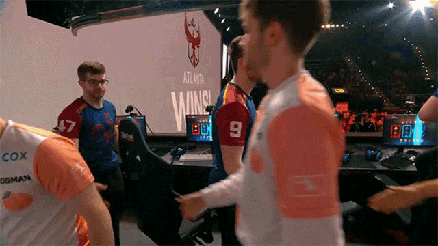 a man wearing a number 9 jersey is standing in front of a screen that says atlanta winning