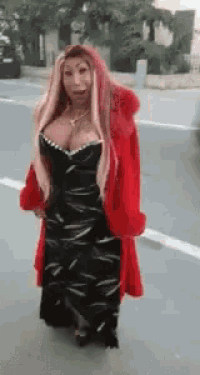a woman wearing a black dress and a red coat