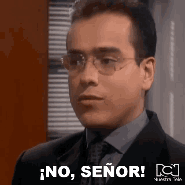 a man wearing glasses and a suit says " no señor "
