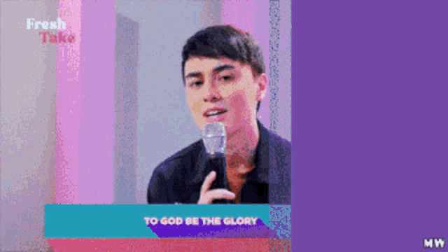 a man singing into a microphone with the words to god be the glory