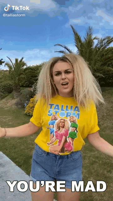 a woman wearing a yellow t-shirt that says talla storm