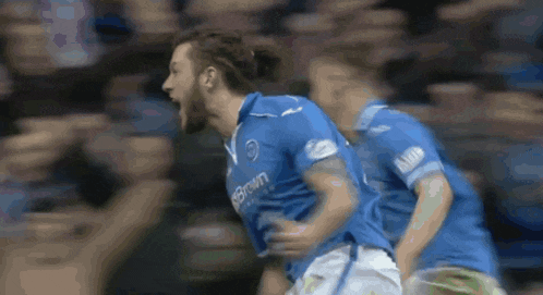 a soccer player wearing a blue shirt that says brown on it