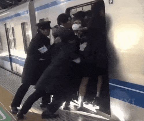 a group of people are trying to get on a train with the letter p on the side