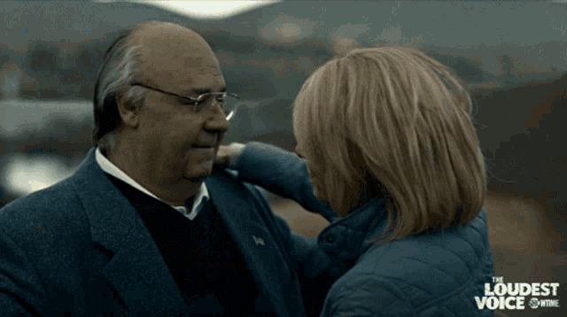 a woman touches a man 's face in a scene from the loudest voice showtime