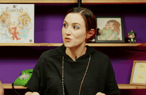 a woman is sitting in front of a shelf with a book called flowercraft on it