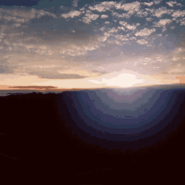 the sun shines brightly through the clouds over the mountains