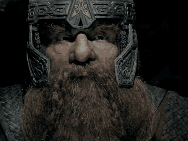 a man with a beard is wearing a helmet that says ' x ' on it