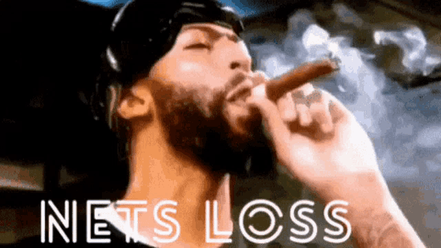 a man with a beard is smoking a cigar in front of a sign that says nets loss