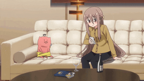 a girl sits on a couch holding a can of soda
