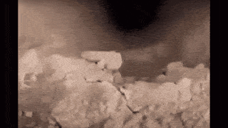 a close up of a piece of ice with a hole in it .