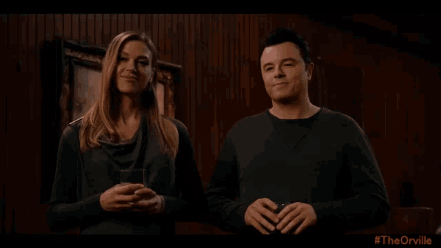 a man and a woman standing next to each other with #theorville written in the corner