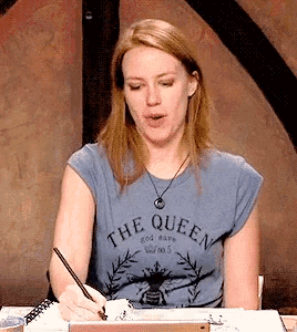 a woman wearing a shirt that says the queen