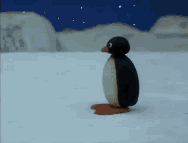 a cartoon penguin is standing in the snow looking up at the sky .