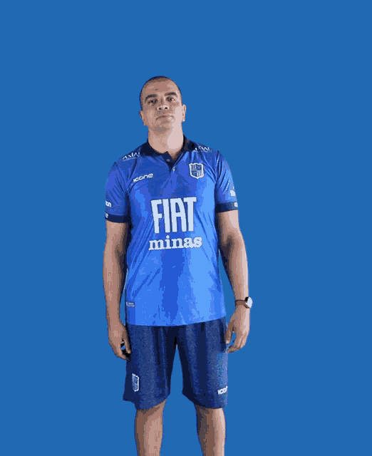 a man wearing a blue fiat minas shirt