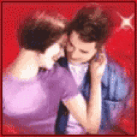 a blurry picture of a man and woman kissing on a red background