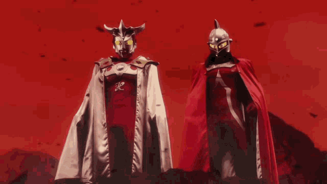 a man in a red cape stands next to a man in a silver cape