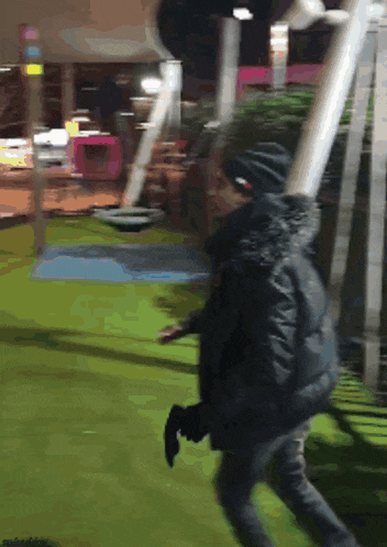 a blurry picture of a person standing on a green field