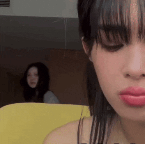 a close up of a woman 's face with red lipstick