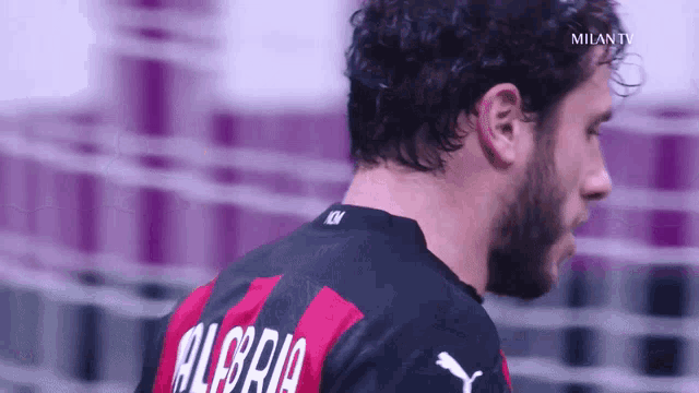 a close up of a man wearing a jersey that says alegria
