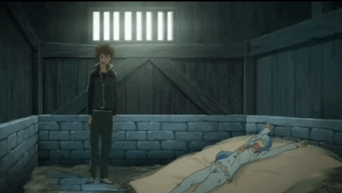 a man stands next to a woman laying on a bed in a dark room